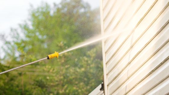 High pressure cleaning the exterior of a house