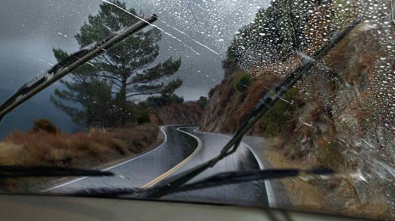 Driving down a road in rainy weather