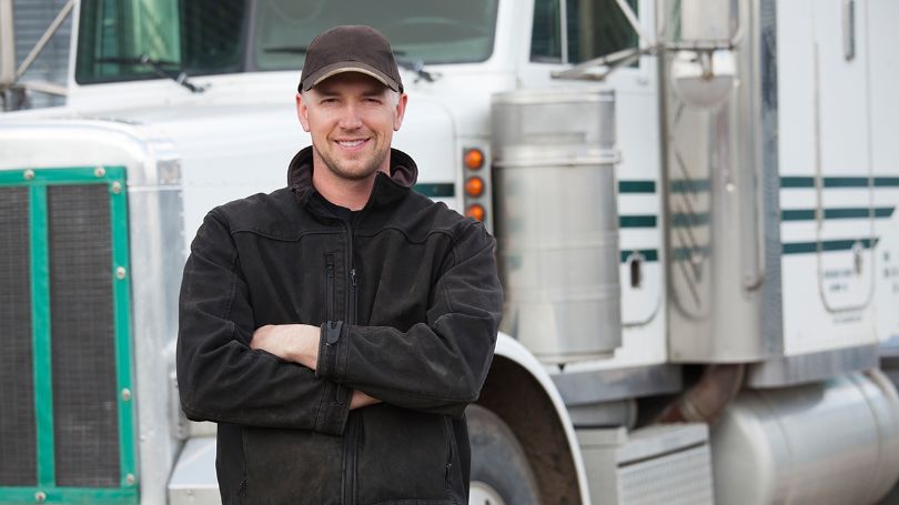 truck driver in front of truck