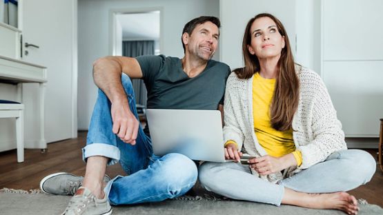 A couple in their living room, pondering new design ideas for the space.