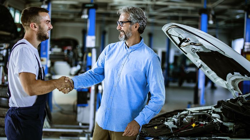 A satisfied customer shaking hands with vendor