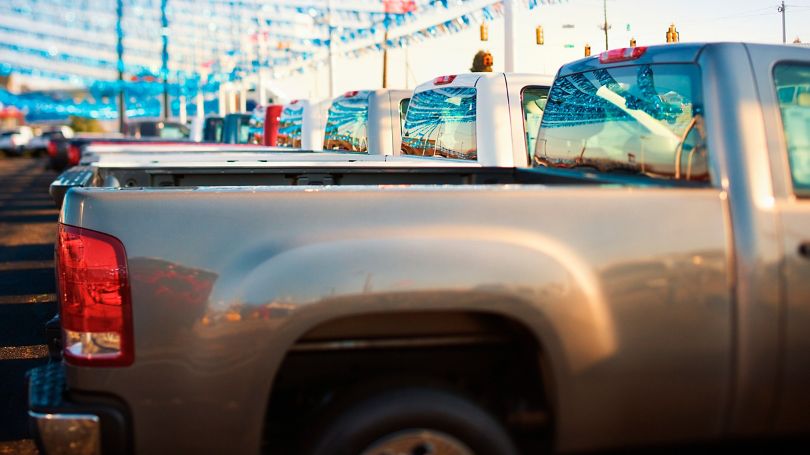 A fleet of pickup trucks in a business parking lot 