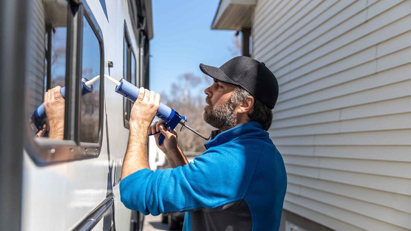A man doing maintenance on his RV