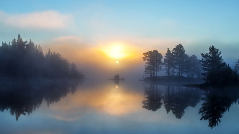 Morning mist rising from a lake