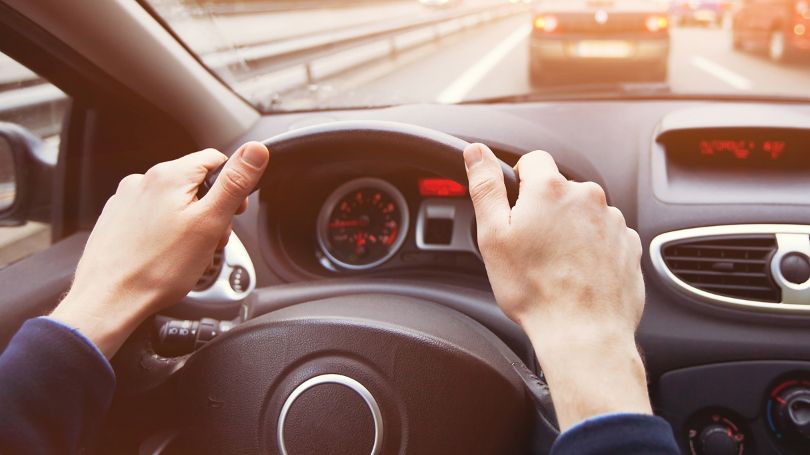 Une femme heureuse se rendant au travail en conduisant