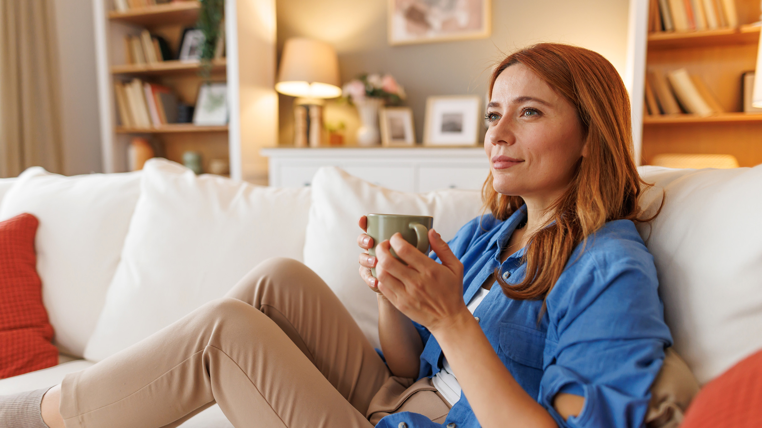 Person relaxing on a sofa at home.