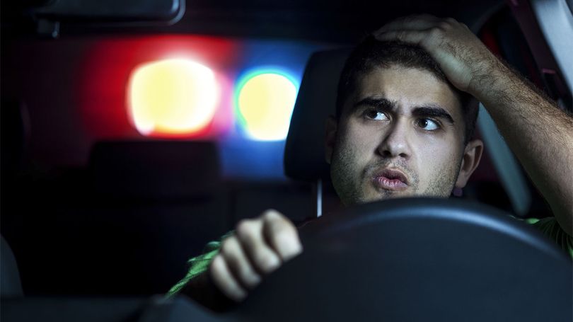 Man looking back at a police car