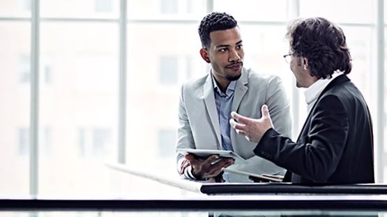 Informal business conversation between two brokers.