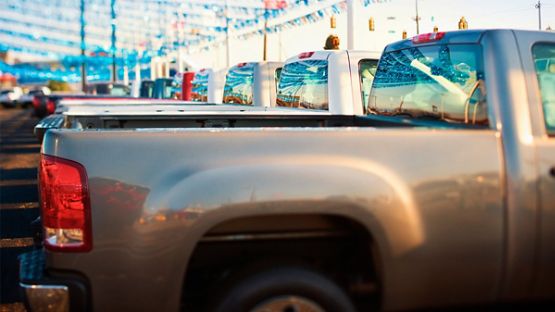 A fleet of pickup trucks in a business parking lot 