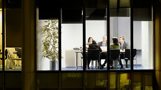 Late night office meeting between business colleagues.