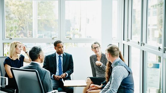 Businesswomen and businessmen on a meeting in conference room