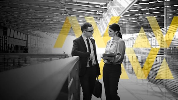 Two people in conversation in office lobby