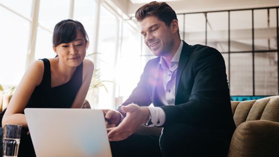 Male client relationship manager having a business meeting with a female client in an office.