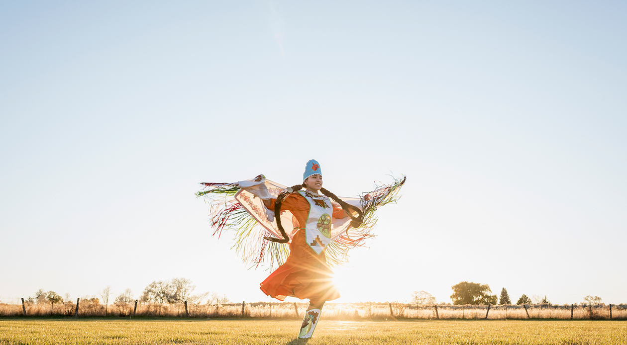Young Native American Woman dancing in traditional dress
