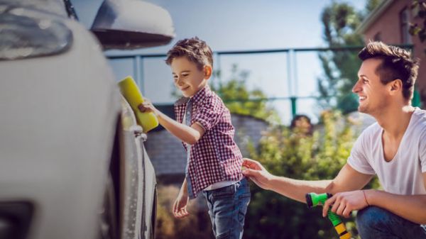 Father and son washing a car