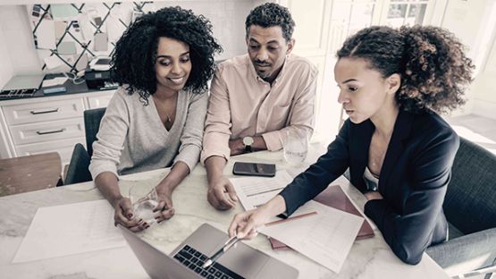 A couple discussing insurance coverage with an insurance broker.