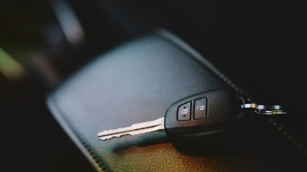 Car key resting on centre console in vehicle