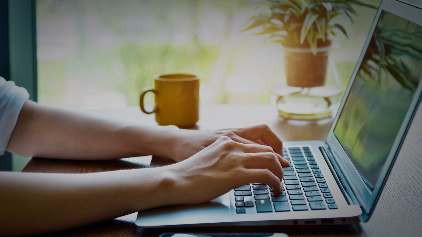 Close up of woman typing on laptop