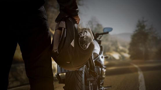Person holding motorcycle helmet