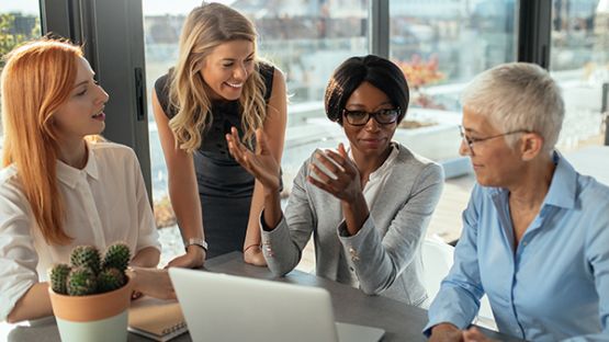 Four women having a meeting.