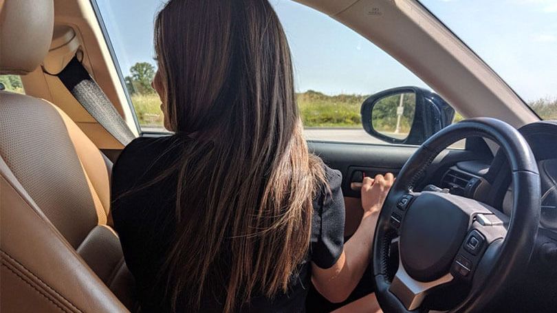 Driver turning to check for cyclists while opening car door