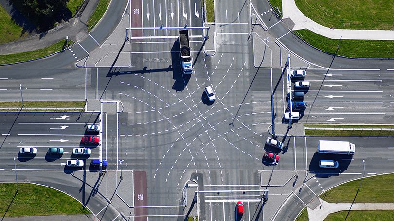 Cars safely navigating a busy intersection
