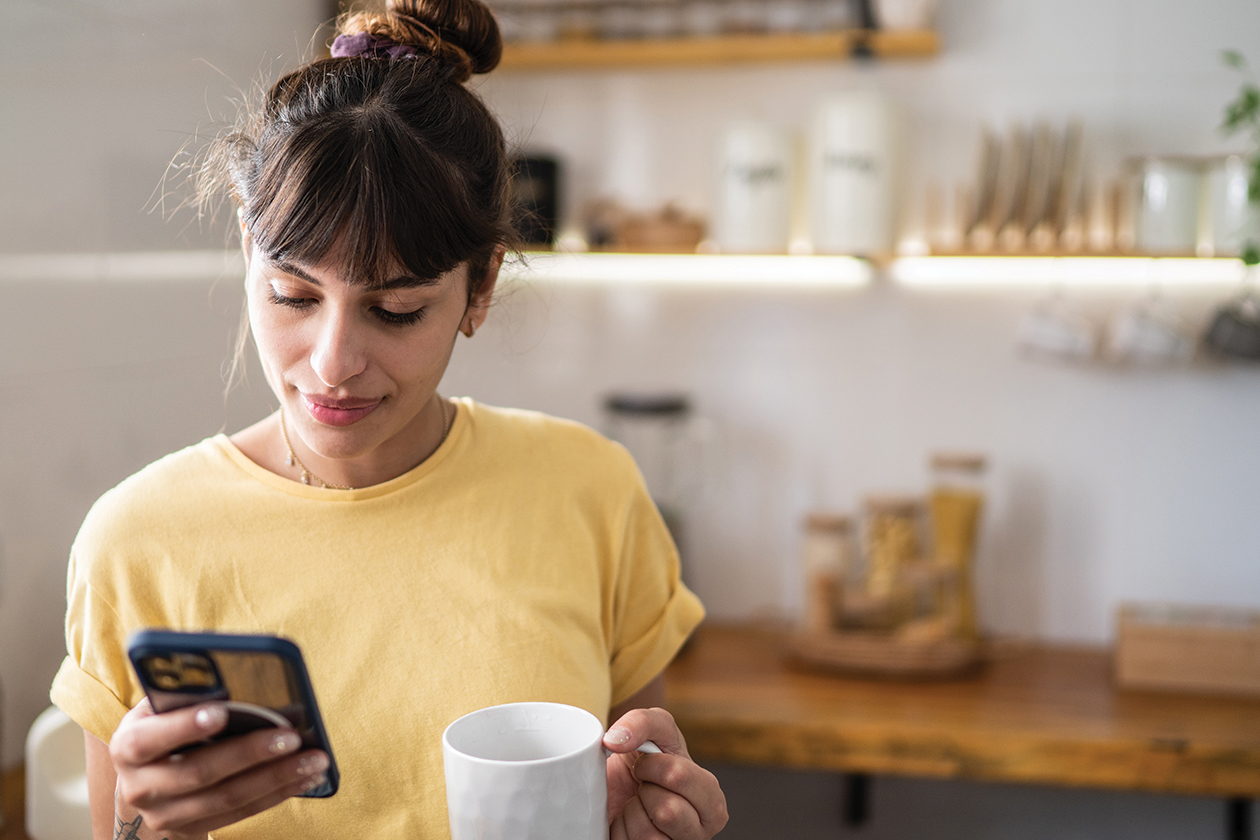 A woman looking through her cellphone for local information on her phone.