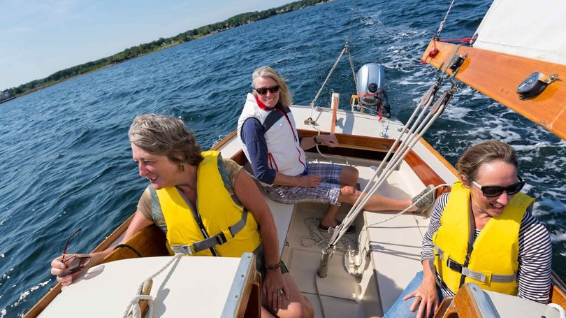 A group of women enjoying a beautiful day of sailing.