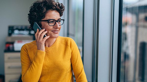 Woman on cell phone looking out window