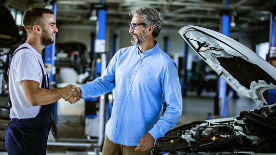 A satisfied customer shaking hands with vendor