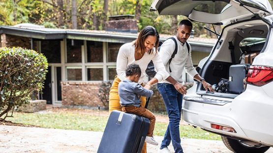 A young family packing their vehicle as they react to an wildfire evacuation order.