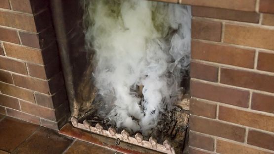 Smoke rising from fireplace