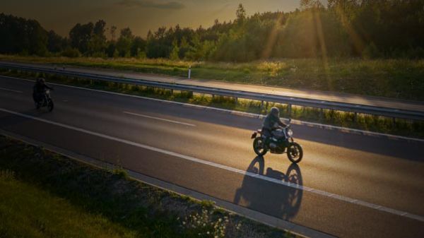 Empty highway with two motorcyclers travelling 