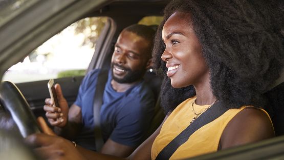 Happy couple driving in a car. 